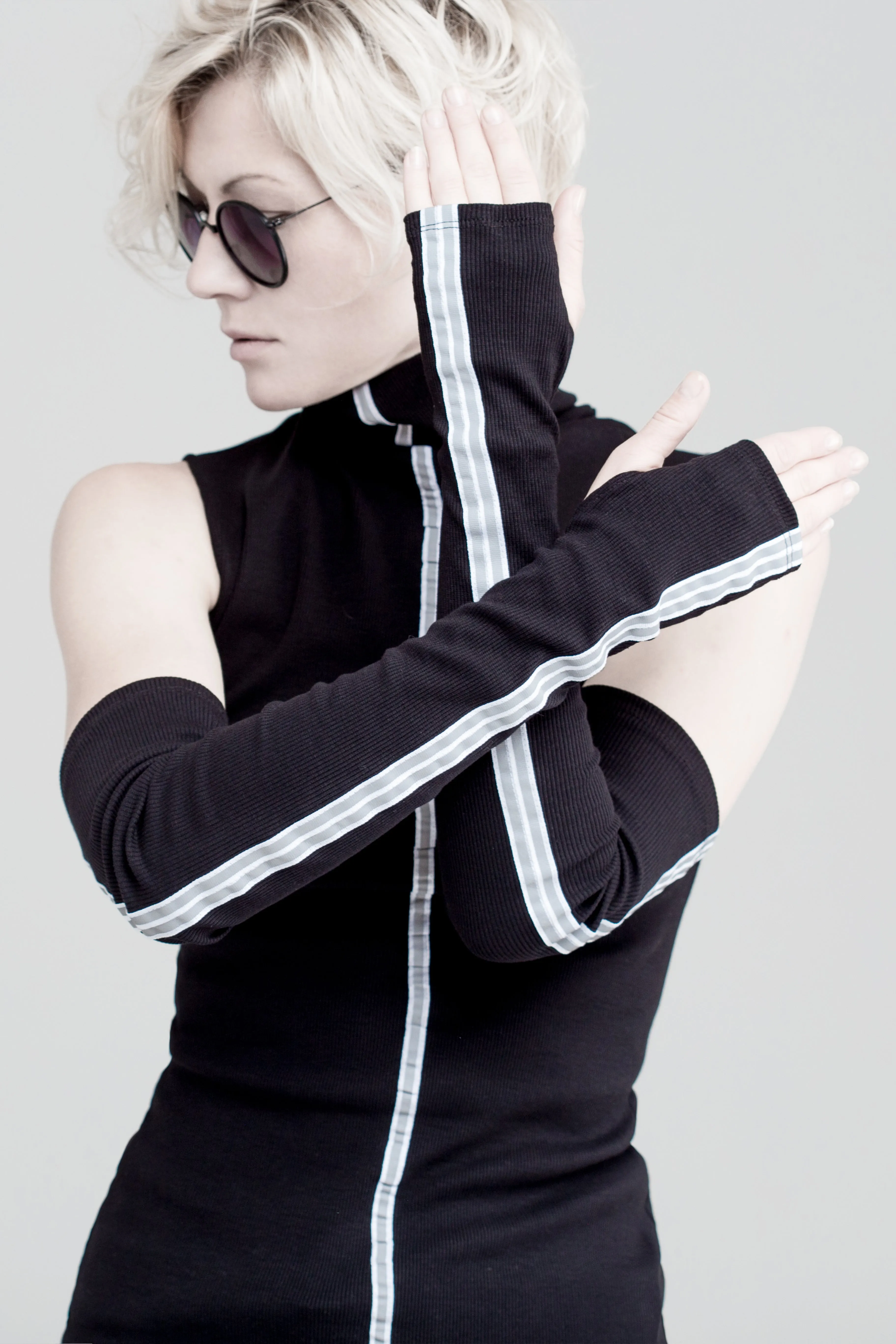 Black sleeveless turtleneck top with long fingerless gloves