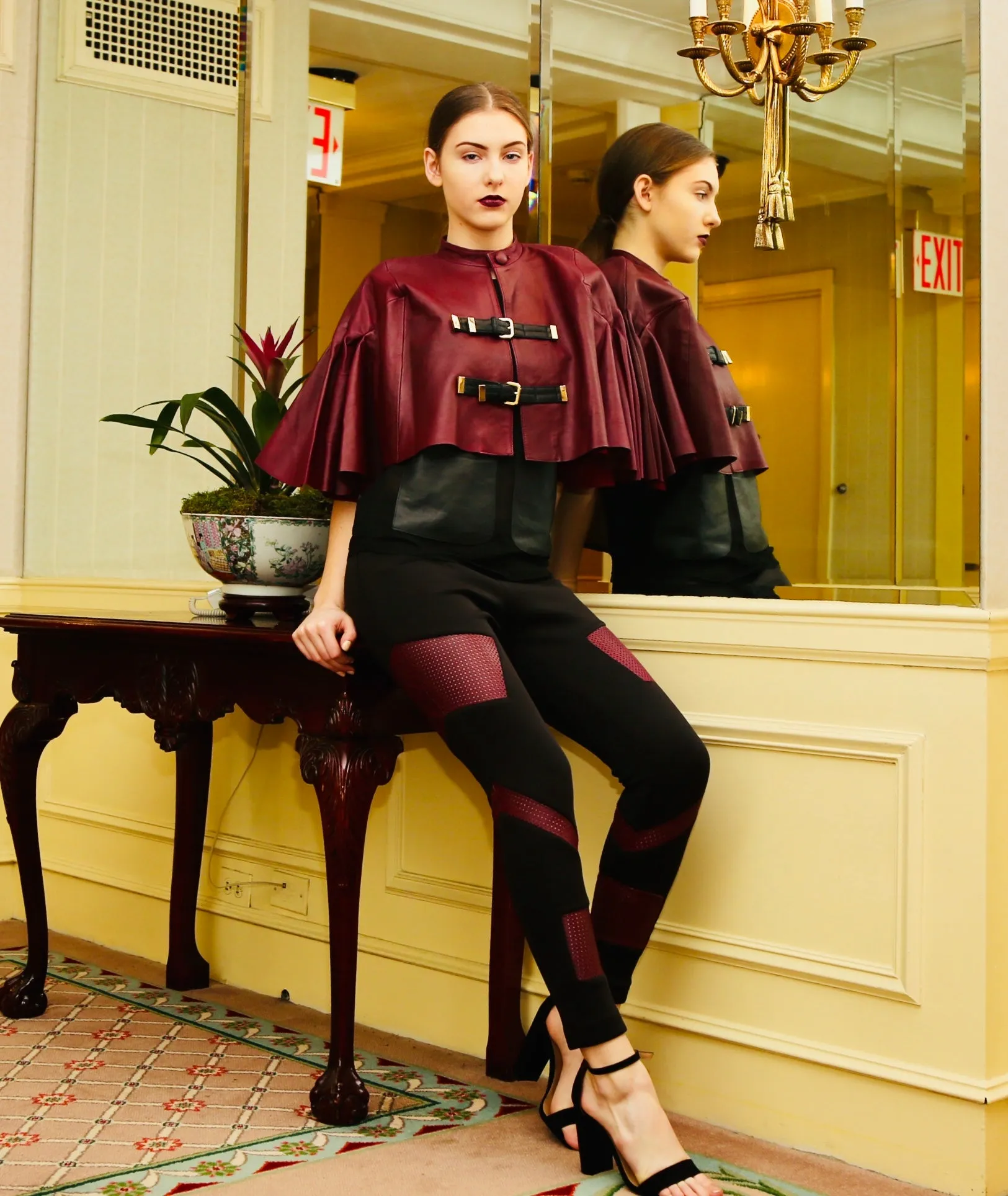 Leather buckled cape with pleated sleeves